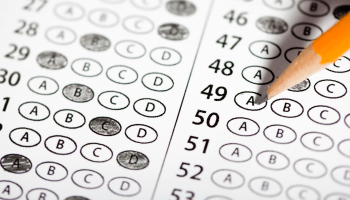 Image of a pencil atop a standardized test paper.
